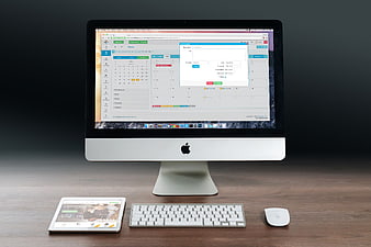 Apple iMac with Magic Keyboard and Mouse on Wooden Desk