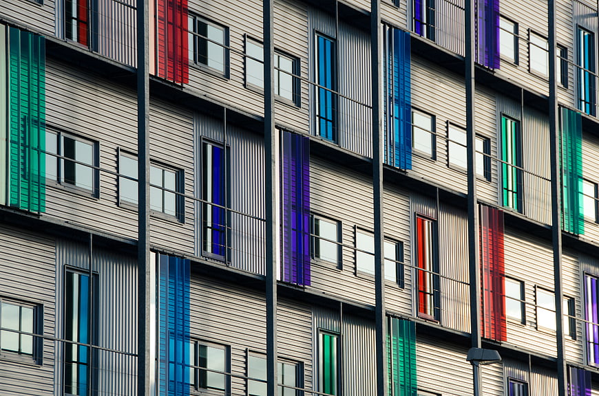Modern apartment facade with colorful vertical window panels
