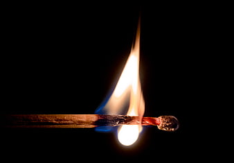 Lit Matchstick Burning Against Black Background