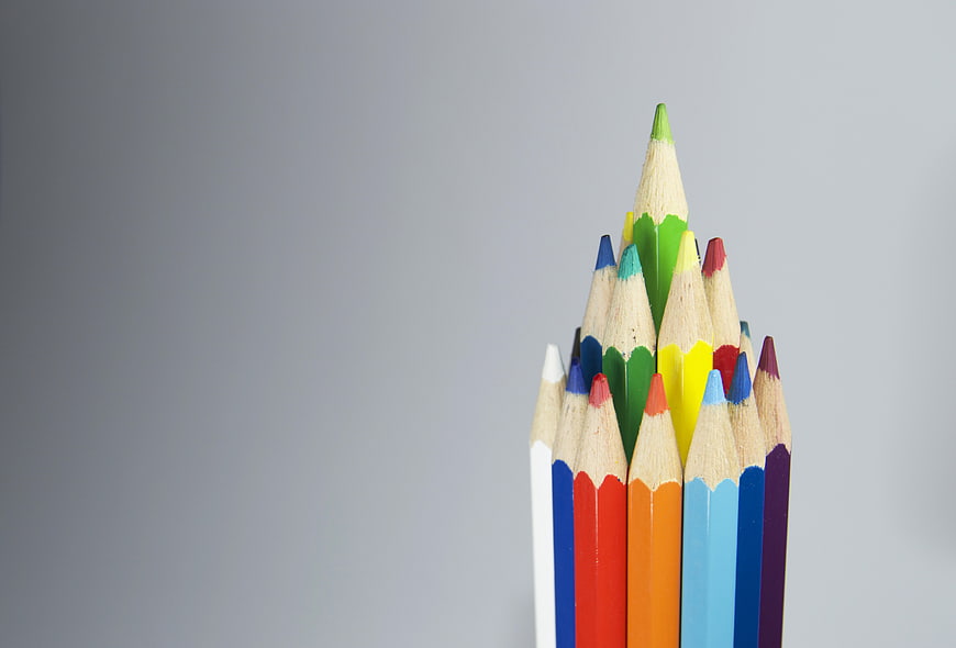 Close-up of sharp colored pencils on gray background