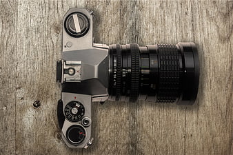 Vintage SLR Camera on Rustic Wooden Background