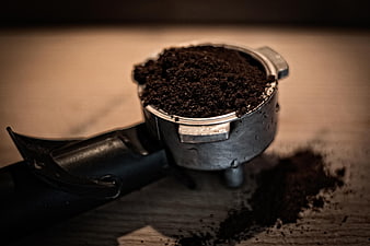 Close-up of espresso portafilter with coffee grounds