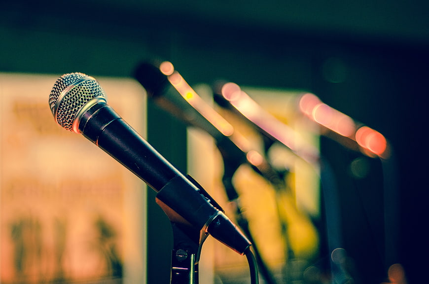 Close-up of microphones on stage with blurred background
