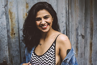 Happy Woman Smiling Against Rusty Metal Wall