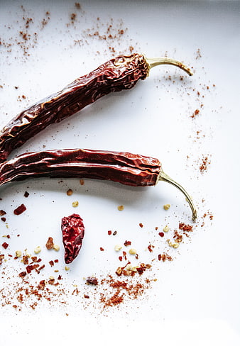 Dried red chili peppers and spices on white background