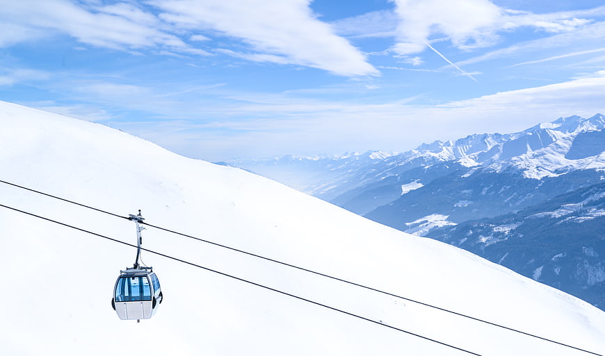 Gondola Lift on Snowy Mountain Slope with Alpine View
