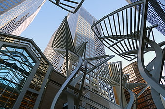 Low angle view of modern city skyscrapers and abstract metal sculpture