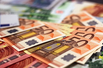 Close-up of scattered Euro banknotes with shallow depth of field