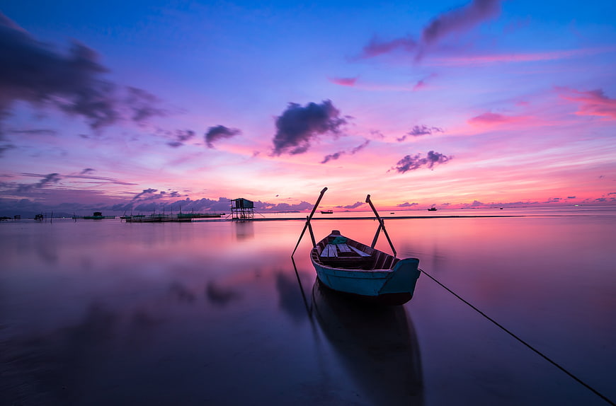 Long Tail Boat Silhouette at Vibrant Pink and Purple Sunset