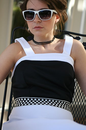 Woman in Retro Sunglasses and Black and White Dress