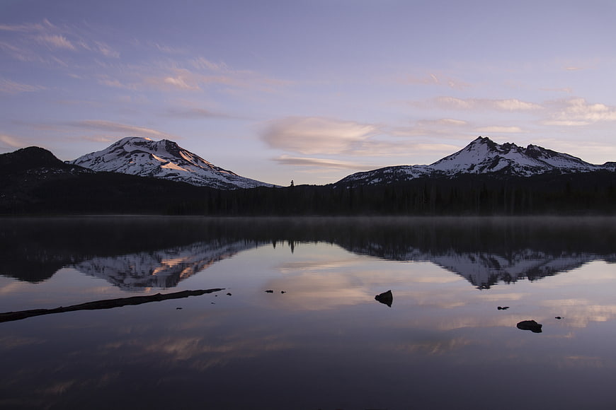 Serene Mountain Lake Reflection at Dawn with Mist