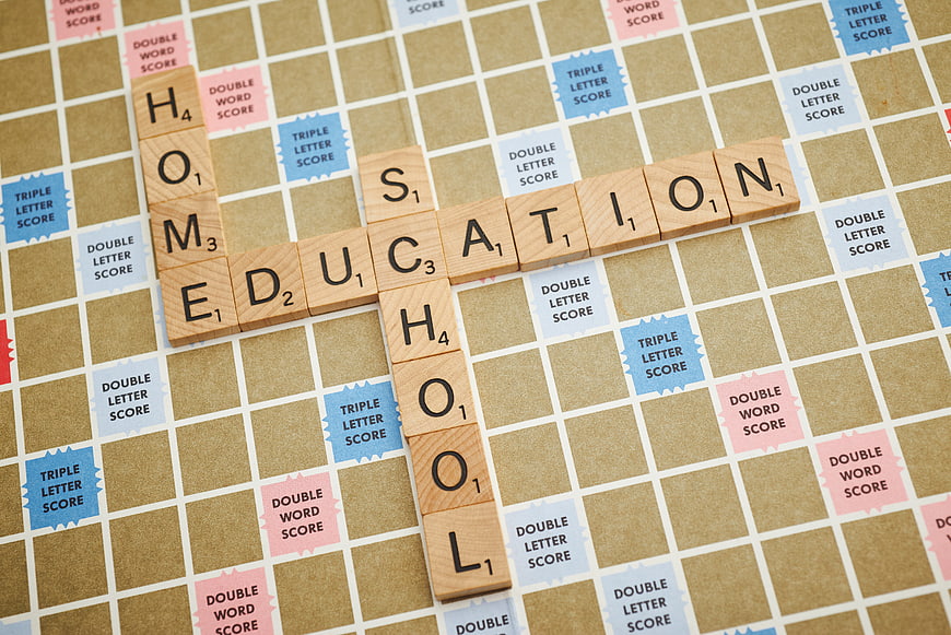 Scrabble board spelling education and school with wooden tiles