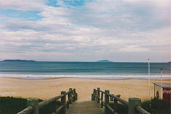 Wooden Boardwalk Leading to Sandy Beach and Ocean