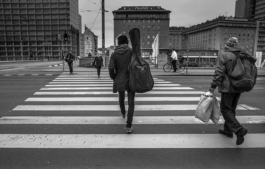 Pedestrians crossing zebra crossing in urban city street