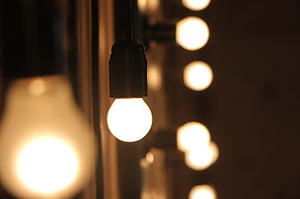 Glowing light bulb with bokeh background
