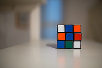 Solved Rubik's Cube on White Surface with Copyspace