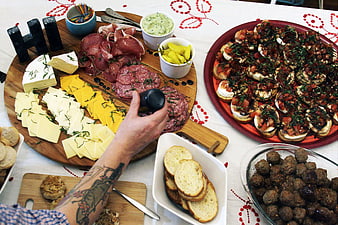 Gourmet Charcuterie Board and Appetizers on Embroidered Table