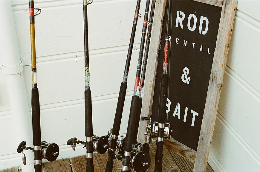 Fishing Rods and Rental Bait Sign on Wooden Deck