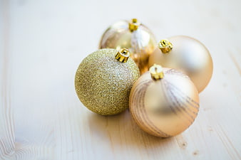 Gold Christmas Ornaments on Light Wooden Background
