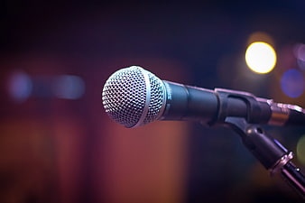 Close-up of Microphone on Stage with Bokeh Lights