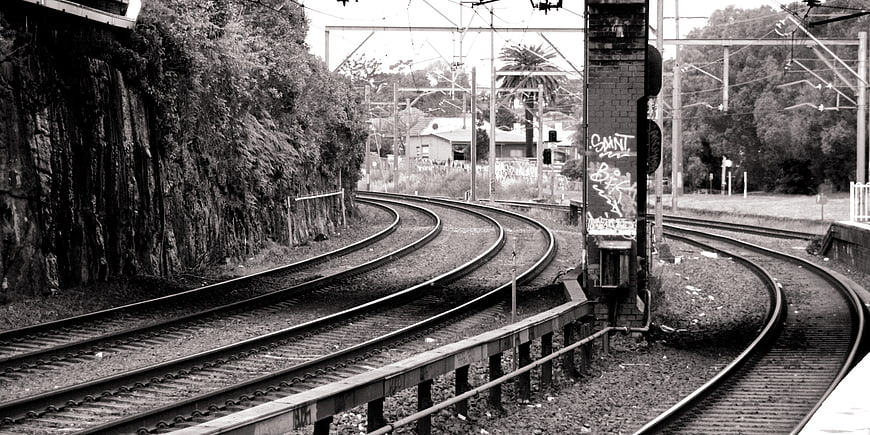 Curved Railway Tracks in Black and White Urban Landscape