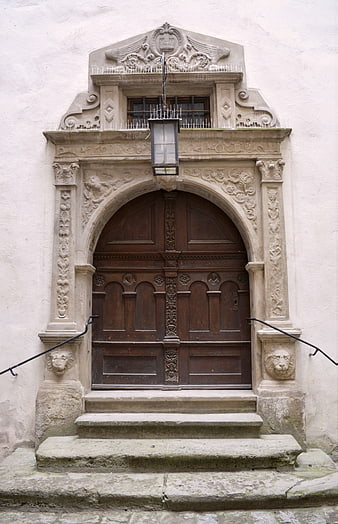 Ornate Historic Stone Archway with Wooden Door