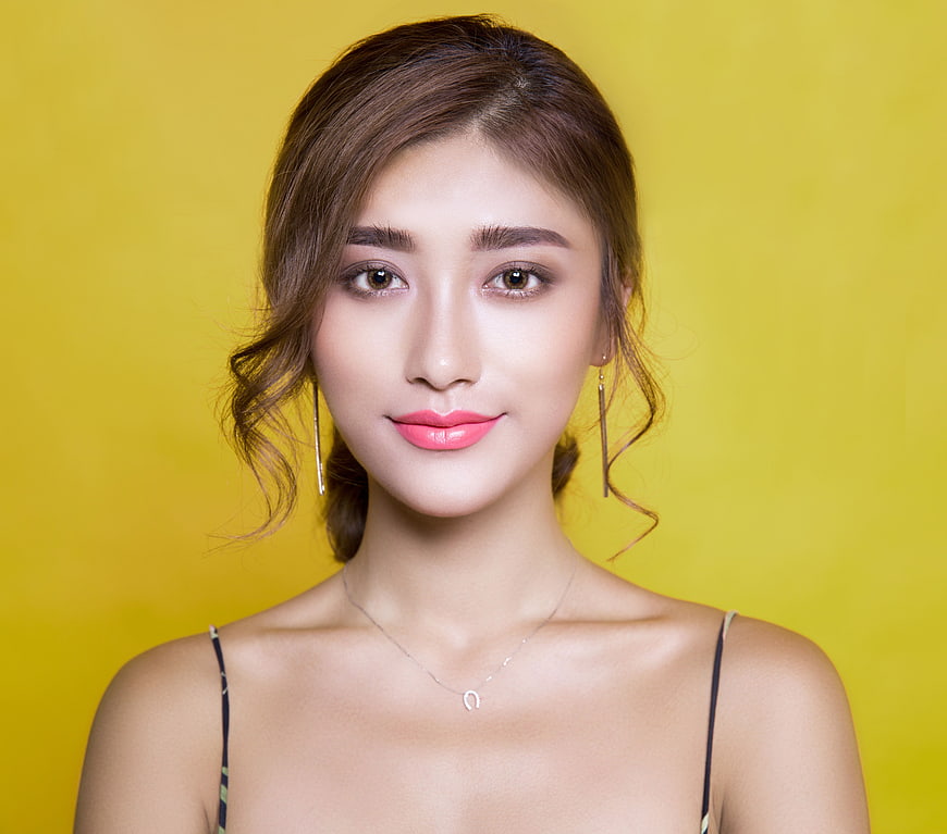 Portrait of Woman with Pink Lips on Yellow Background
