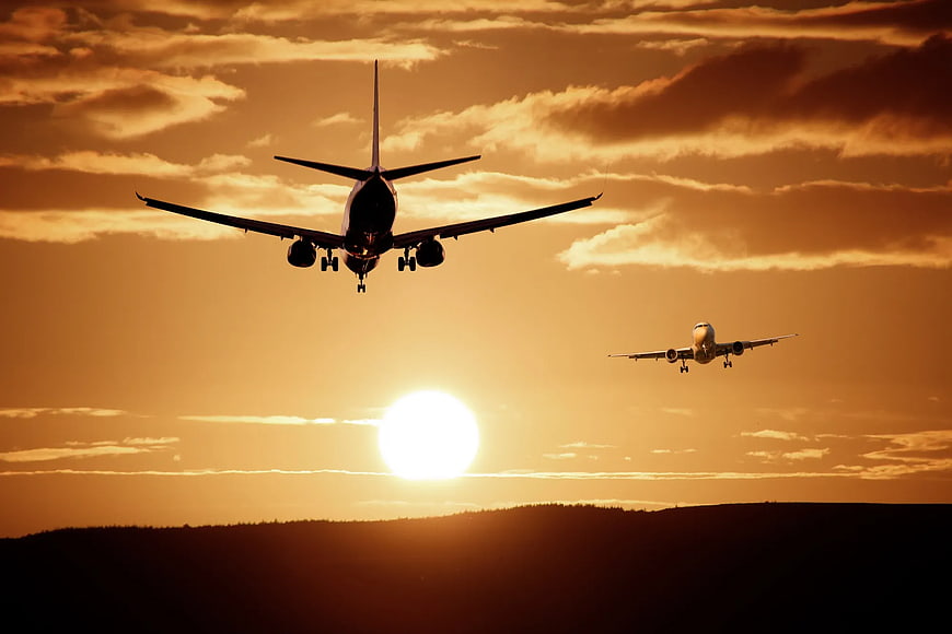 Two Airplanes Landing at Golden Sunset