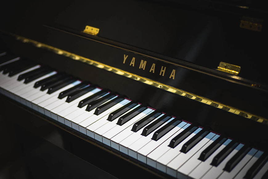 Close-up of Black Yamaha Piano Keys and Logo