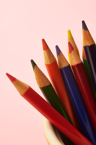 Colorful Colored Pencils in a Cup on Pink Background