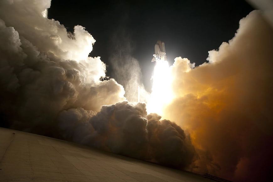 Space Shuttle Launch at Night with Massive Smoke Plume