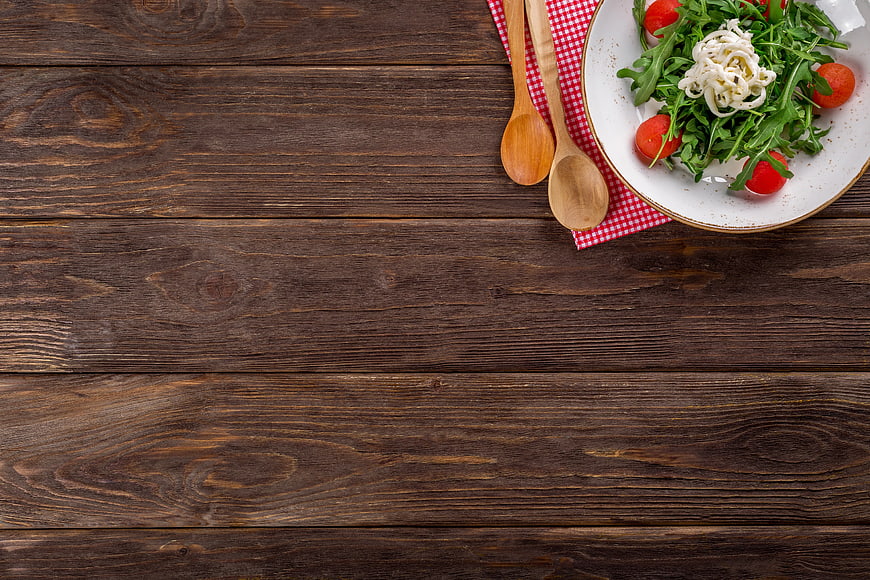 Fresh Arugula Salad with Tomatoes on Rustic Wooden Table