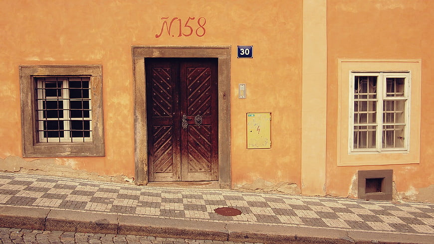 Old European Street with Orange Facade and Wooden Door