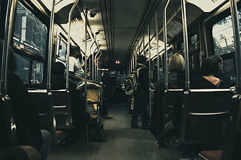 Interior of a crowded commuter train with passengers