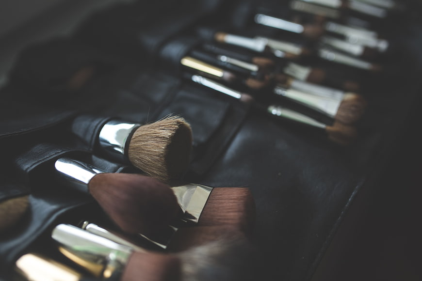 Professional makeup brushes in black leather roll