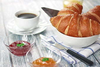 Fresh Croissants with Coffee and Jam on Wooden Table
