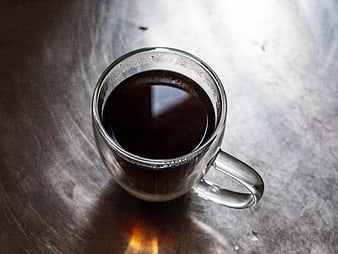 Top View of Black Coffee in Clear Glass Mug on Metal Table
