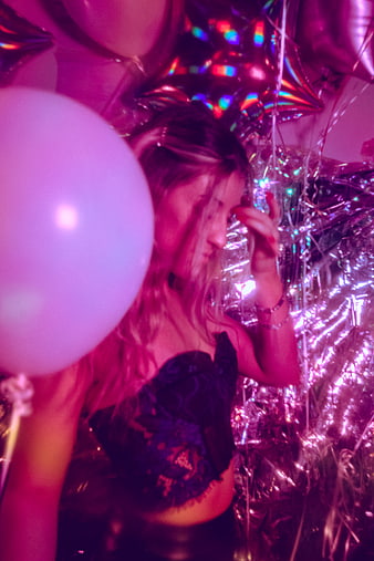 Woman at Neon Party with Balloons and Disco Lights