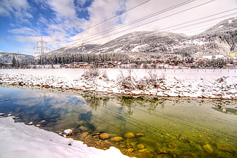 Snowy River with Mountain Village Reflection in Winter