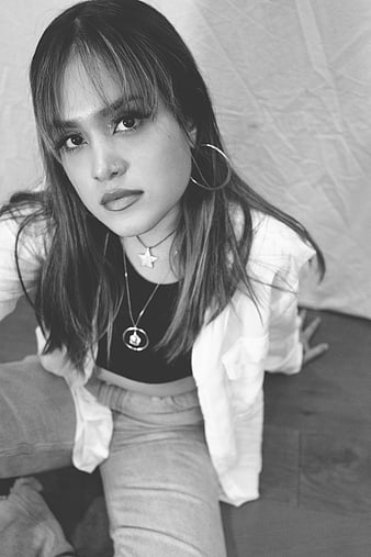 Black and white portrait of stylish young woman with hoop earrings