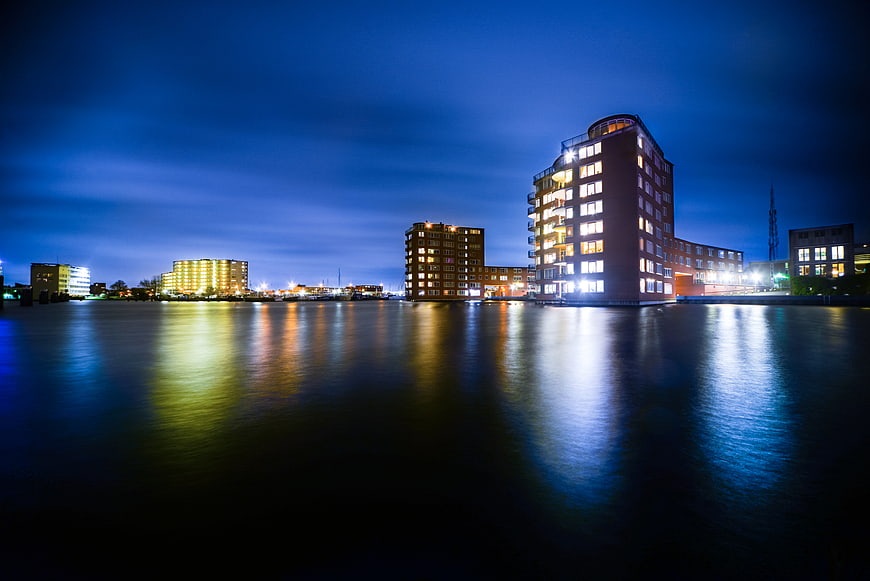 Night cityscape of Zaandam with building reflections on water