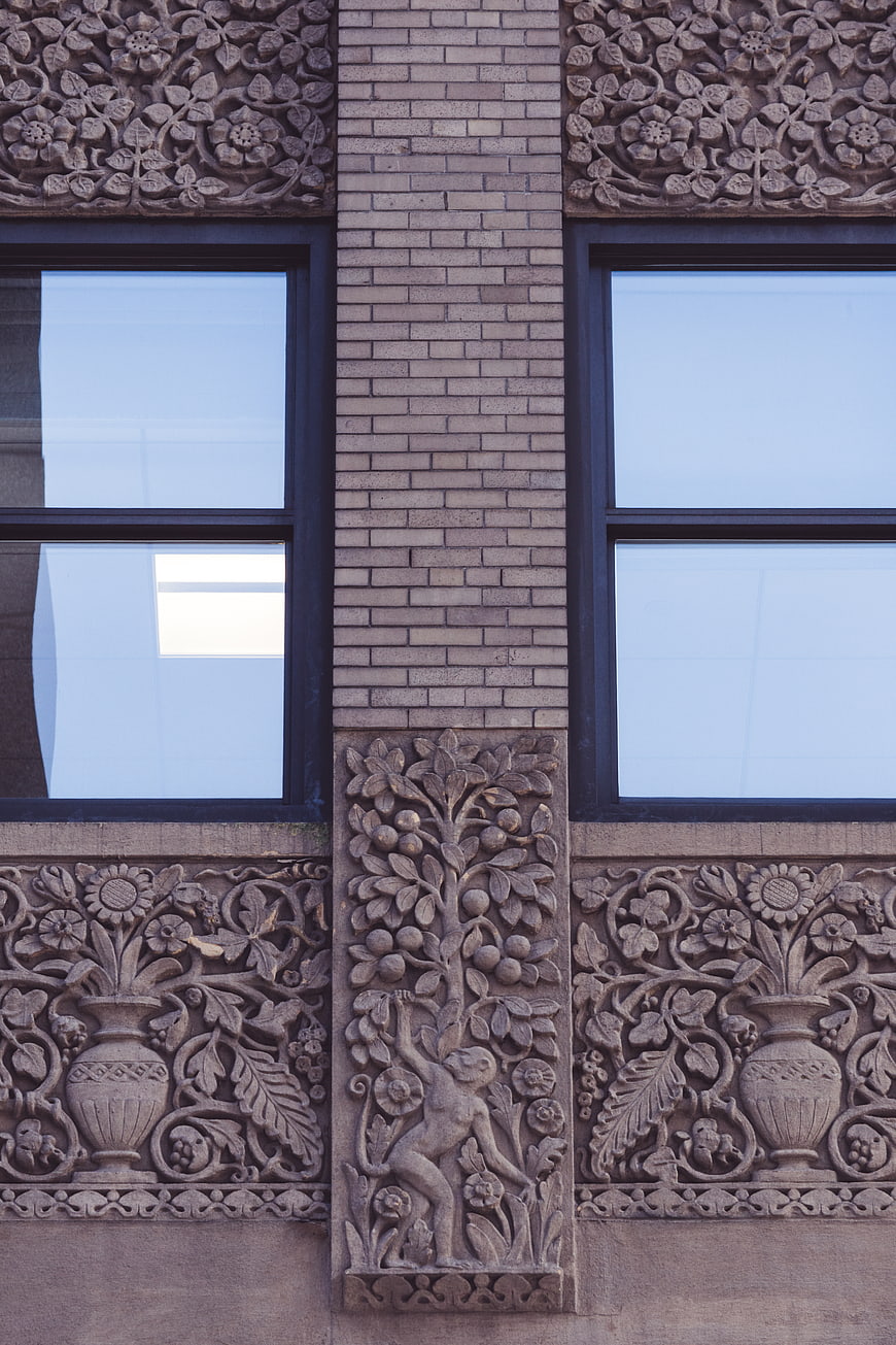 Ornate architectural facade with carved stone details and windows