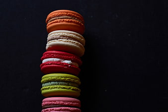Stack of colorful macarons on dark background