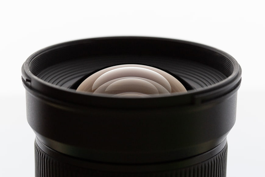 Close-up of camera lens with aperture blades on white background