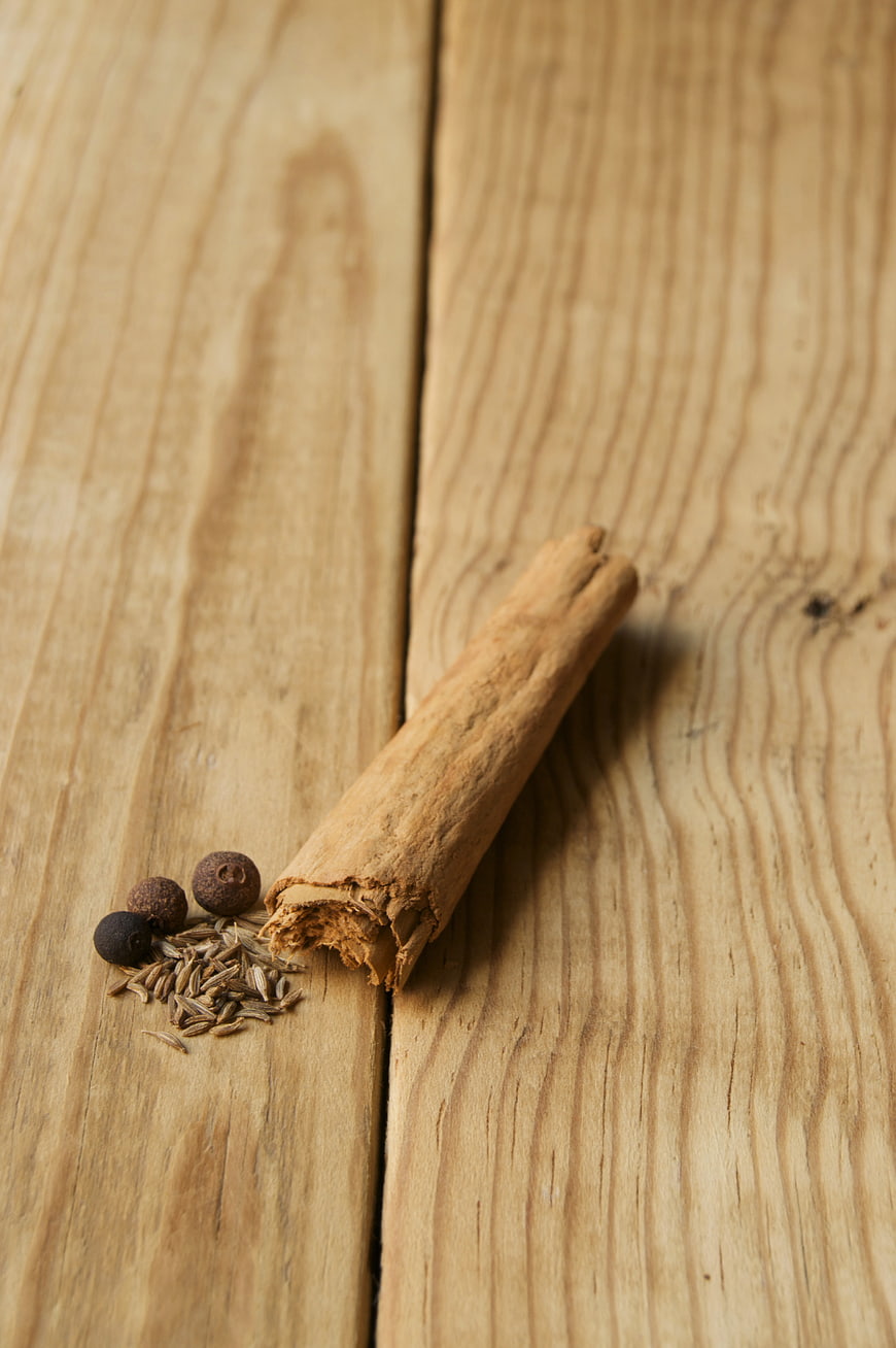 Cinnamon Stick and Spices on Wooden Background