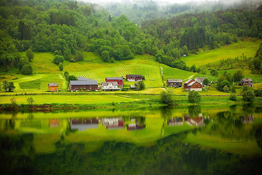 Scenic Norwegian Village with Houses Reflected in Lake