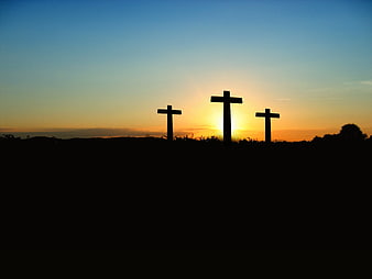 Silhouette of Three Crosses at Sunset