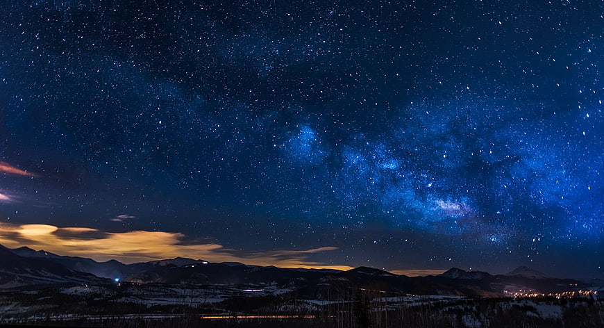 Milky Way Galaxy Over Snowy Mountain Range at Night