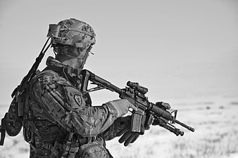 Soldier in Camouflage Holding Rifle in Desert