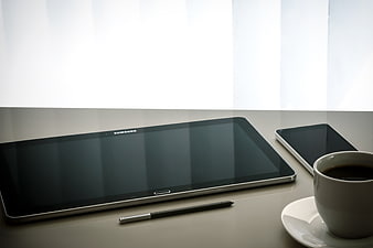 Modern tablet, smartphone, and coffee on a desk